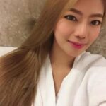 KL Escort Girl Woman in white robe with long blonde hair Malaysia Sex Service