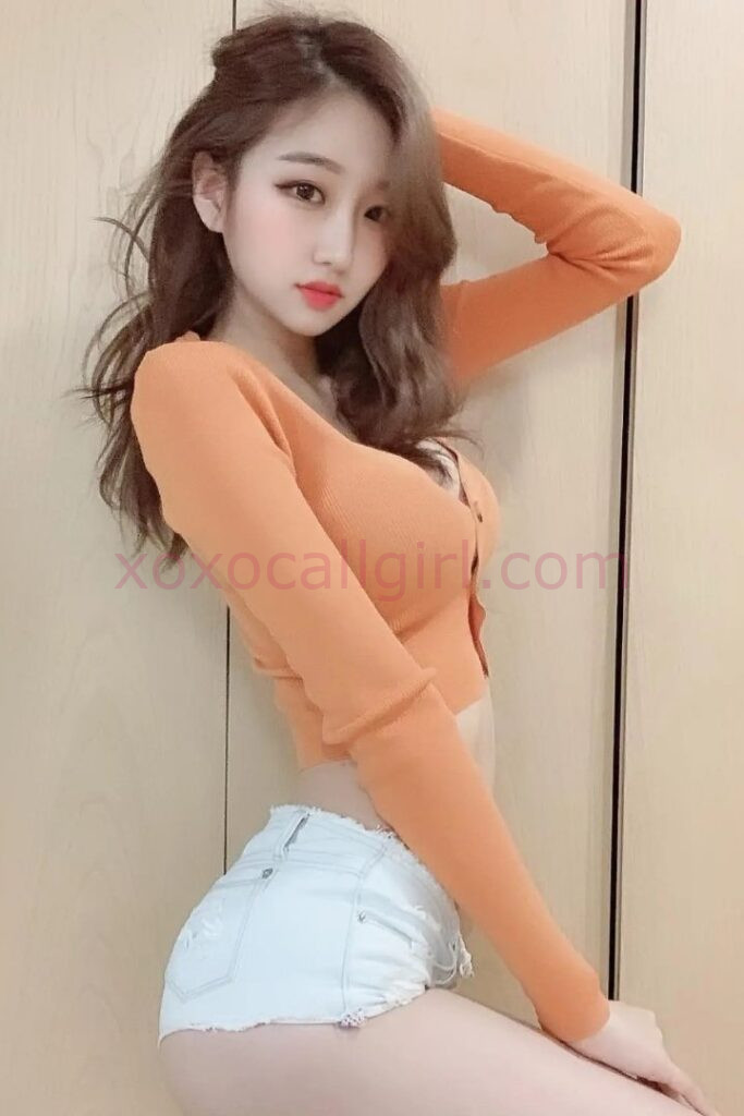 KL Escort Girl Beautiful Chinese escort in Kuala Lumpur wearing white shorts and an orange top. Malaysia Sex Service