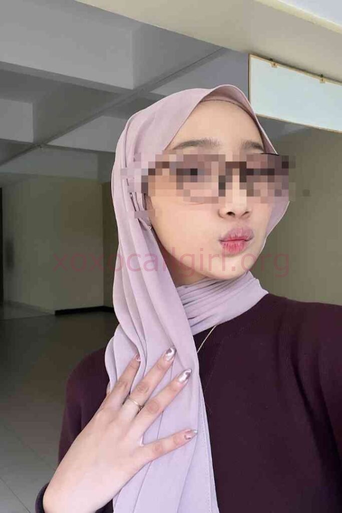 KL Escort Girl Woman in hijab and sunglasses pouting, showing off metallic nails. Malaysia Sex Service