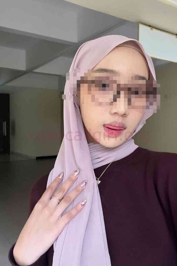 KL Escort Girl Young woman in a lilac hijab and burgundy sweater, wearing sunglasses and a ring. Malaysia Sex Service